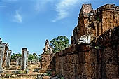 Angkor - Eastern Mebon - towered passageways leading to the first enclosure of the temple,  with stone lions guarding the entrance.